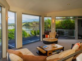 A living room with a coffee table and seating area at Bay View Escape - Whitianga Holiday Home in Whitianga