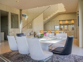 A dining room with a table and chairs at Bay View Escape - Whitianga