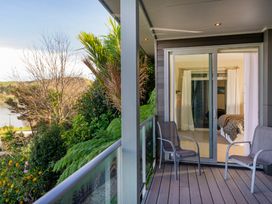 A balcony with chairs and a view at Bay View Escape - Whitianga Holiday Home Whitianga