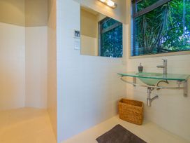 A bathroom with a sink and shower area at Bay View Escape - Whitianga Holiday Home Whitianga