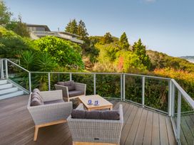 An outdoor seating area with chairs and a table at Bay View Escape - Whitianga