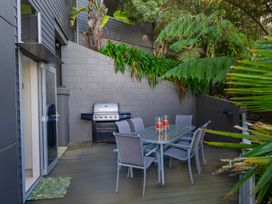 An outdoor patio with a table and chairs at Bay View Escape - Whitianga