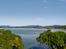 A view of water and trees with mountains in the background at Bay View Escape - Whitianga Holiday Home, Whitianga