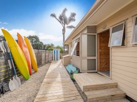 An outdoor area with kayaks and paddles at Whangapoua