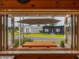 A window view showing a table and umbrella at Whangapoua