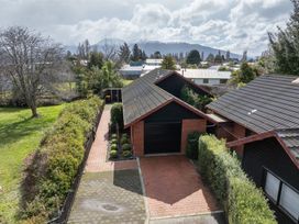 An aerial view of a house with a driveway and garden at Te Anau - Holiday Home