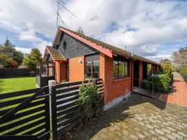 A house with a garden and pathway at Te Anau - Holiday Home