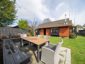 A garden with a table and chairs at Te Anau - Holiday Home 