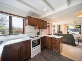 A kitchen with a stove and cabinets at Te Anau - Holiday Home