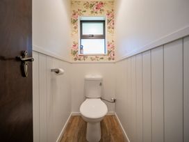 A bathroom with a toilet and window at Te Anau - Holiday Home