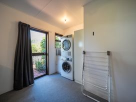 A laundry room with a washing machine and dryer at Te Anau - Holiday Home