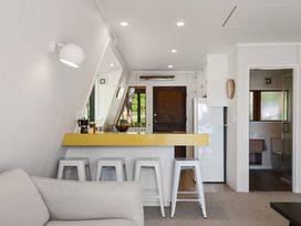 A kitchen with a counter and bar stools at Rotorua 