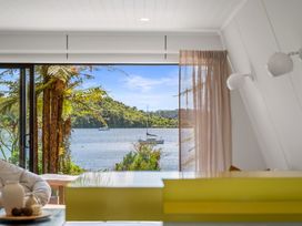 A living room featuring a view of water and trees at Rotorua