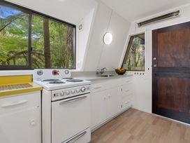 A kitchen featuring a stove, sink, and window at Rotorua