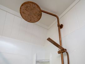 A shower setup with a showerhead and mixer in a bathroom at Rotorua