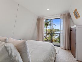 A bedroom with a view and a sliding door at Rotorua