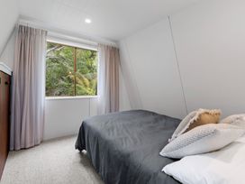 A bedroom with a bed and window at Rotorua