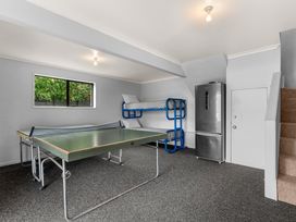 A game room with a ping pong table and a bunk bed at Snells Beach 