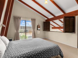A bedroom with a bed and window at Snells Beach