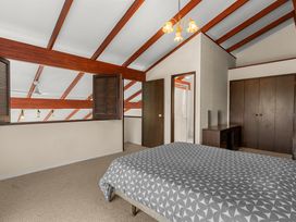 A bedroom with a bed and closet in Snells Beach 