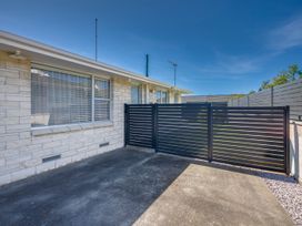 An outdoor space with a fence and concrete surface at Havelock North Holiday Home