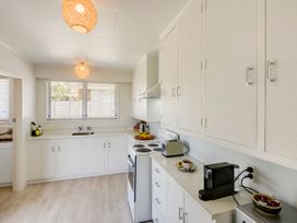 A kitchen with a sink and stove at Havelock North Holiday Home