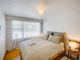 A bedroom with a bed and a window at Havelock North Holiday Home