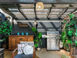 An outdoor area with a grill and seating at Whitianga Holiday Home in Whitianga