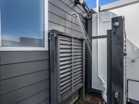 An outdoor shower next to a wall at Whitianga Holiday Home in Whitianga