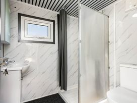 A bathroom with a sink, toilet, and shower at Whitianga Holiday Home in Whitianga