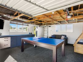A game room with a table tennis table and a sofa at Whitianga Holiday Home in Whitianga