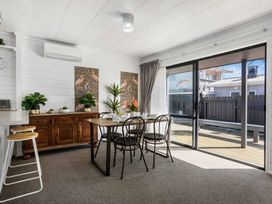 A dining room with a table and chairs at Whitianga Holiday Home in Whitianga