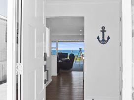 An entryway leading to a living space with an ocean view at Tindall's Beach Whangaparaoa Peninsula