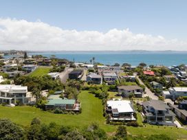An aerial view of houses and the ocean at Tindall's Beach Whangaparaoa Peninsula