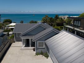 An outdoor view of a house with ocean view at Tindall's Beach in Whangaparaoa Peninsula