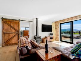 A living room with a wood stove and television at The Old Barn in Manchester