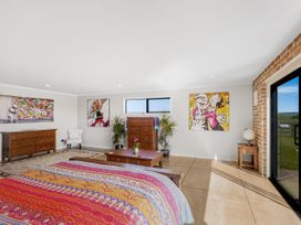 A bedroom with a bed and dresser at the property in location