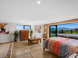 A bedroom with a bed and dresser at an unknown location