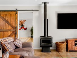 A living room with a fireplace and television at the property