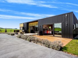 A house with a patio and grill at a rural location