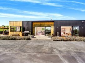 A modern building with a patio and driveway at a property in an open area
