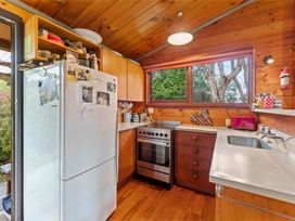 A kitchen with a refrigerator, oven, and sink at Hatepe Lake Taupo Retreat Lake Taupo