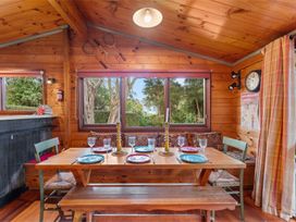 A dining room with a table set for dinner at Hatepe Lake Taupo Retreat in Lake Taupo