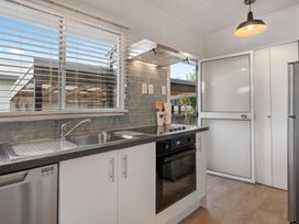 A kitchen with appliances and a sink at Taupo - Holiday Home