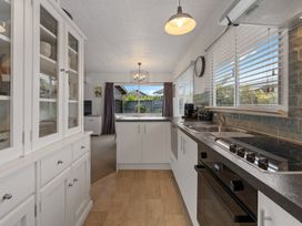 A kitchen with cabinets and appliances at Taupo - Holiday Home
