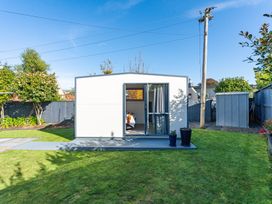 A garden with a shed and a modern outdoor structure at Taupo - Holiday Home 