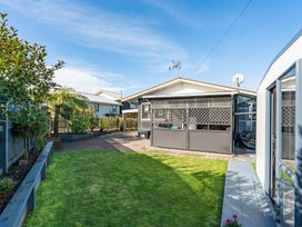 A garden with grass and a pathway at Taupo - Holiday Home