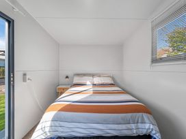 A bedroom with a bed and nightstand at Taupo - Holiday Home