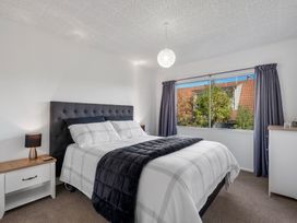 A bedroom with a bed and a window at Taupo - Holiday Home 