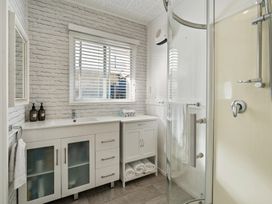 A bathroom with a shower and sink at Taupo - Holiday Home